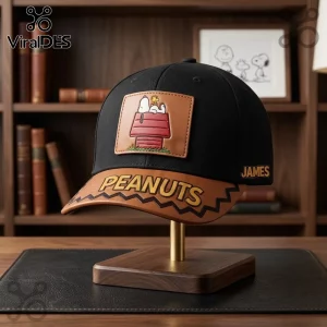Peanuts Snoopy Red Doghouse Custom Name Baseball Cap featuring a leather patch of Snoopy on a black crown and tan brim.