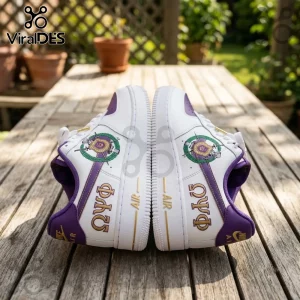 Custom Omega Psi Phi Purple Air Force 1 Sneakers featuring white leather, Greek lettering, and crests on wooden tabletop.