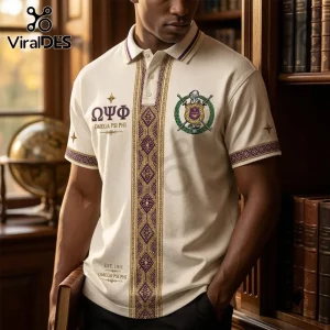 Premium Omega Psi Phi Cream Polo Shirt with purple geometric front placket, gold embroidery, and fraternity crest logo.