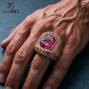 Penrith Panthers 60th Anniversary Gold Ring featuring a red gemstone, panther emblem, and text reading 1966 to 2026.