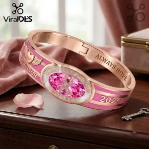 Breast Cancer Awareness 2026 Survivor hinged bracelet in rose gold with a central pink gemstone and engraved text.