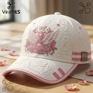Breast Cancer Awareness 2026 Rose baseball cap in cream fabric with pink embroidered ribbon, wings, and rose floral motifs.