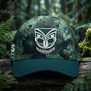 New Zealand Warriors 2026 Junior Te Taiao cap with green fern camouflage pattern and embroidered team logo on a log background.
