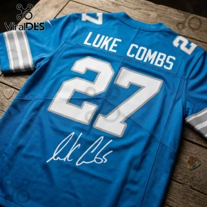 Detroit Lions Luke Combs 2027 Tour blue football jersey featuring white lettering, the number 27, and a replica signature.