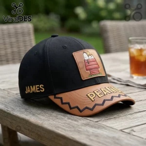 Peanuts Snoopy Red Doghouse Custom Name Baseball Cap featuring a leather patch on a black hat with brown zig-zag brim.
