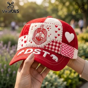 Delta Sigma Theta Patchwork Red Baseball Cap featuring crest embroidery, heart patterns, and DST text on a red background.