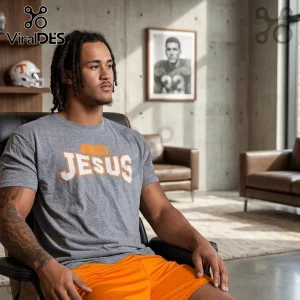 Tennessee Volunteers Team Jesus Heather Gray Shirt worn by a man with locs sitting in an office chair.