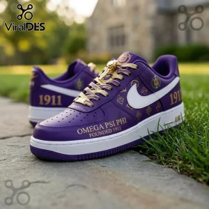 Omega Psi Phi Fraternity Purple Air Force 1 Sneaker with gold laces, 1911 text, and white Swoosh on a stone walkway.