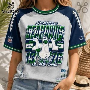 Seattle Seahawks 1976 Embossed Mascot Shirt featuring three cartoon seagulls, team colors, and vintage city graphics.
