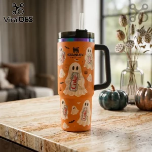 Orange Ghost Diet Coke 40oz Stanley Tumbler with white ghost graphics, black handle, and iridescent rim on a marble surface.