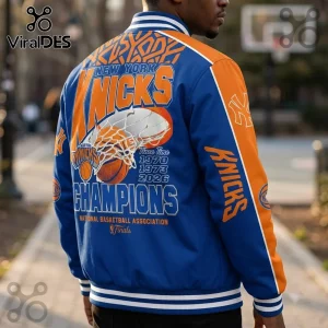 New York Knicks 2026 NBA Finals Champions baseball jacket in royal blue and orange with team graphics and striped cuffs.