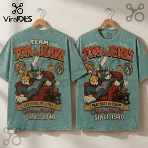 Tom and Jerry 1940 Partners in Crime T-Shirt in acid-wash teal with vintage cartoon graphic on a wooden coat hanger.