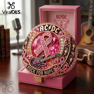 AC/DC Rock For Hope Breast Cancer Awareness Ring featuring a pink crystal, rock band portraits, and a metal guitar motif.