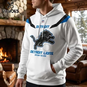 Detroit Lions Nike white performance hoodie featuring a black lion logo, blue text, and NFL shield in a cozy lodge room.
