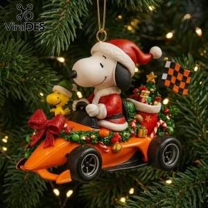 Snoopy Santa Racing Car Christmas Ornament 2026 featuring Snoopy and Woodstock in an orange race car on a pine tree.