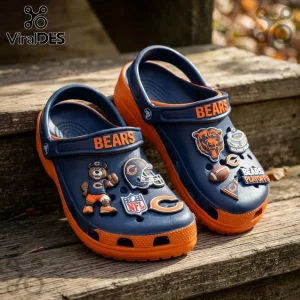 Chicago Bears Navy Blue Playoff Crocs With Charms featuring orange soles and team logos on a wooden surface.
