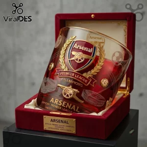 Arsenal FC Premier League Champions 2026 whiskey glass with red tint in a velvet-lined display box with golden engraving.