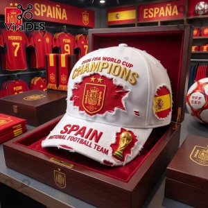Spain 2026 World Cup Champions distressed baseball cap in white with gold embroidery and a red patch in a wooden box.