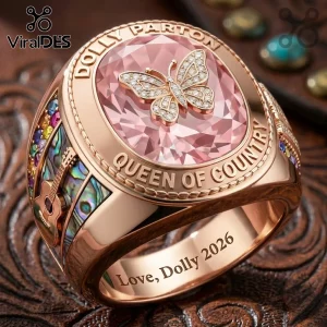 Dolly Parton Queen of Country butterfly ring in rose gold with pink center stone, guitar inlay, and ornate engravings.