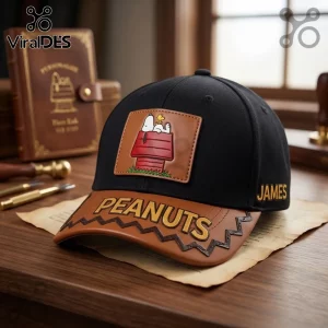 Peanuts Snoopy Red Doghouse Custom Name Baseball Cap featuring a leather patch of Snoopy and the word Peanuts on the visor.