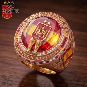 Spain National Football Championship gold ring featuring a central Spanish flag, two gold trophies, and red gem inlays.