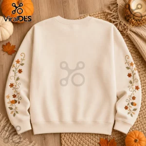 Personalized Snoopy Autumn Pumpkin Spice Sweatshirt in cream with embroidered floral and pumpkin sleeve detail.