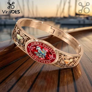 Jimmy Buffett Margaritaville gold tone engraved bracelet with a red center stone, palm tree motifs, and island imagery.