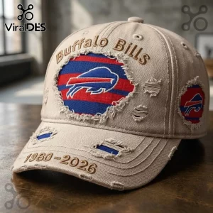 Buffalo Bills 1960-2026 Distressed Baseball Cap in beige with a frayed blue and red team logo patch on a wooden surface.