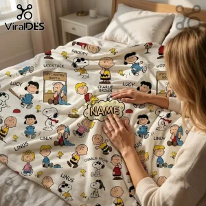 Peanuts Snoopy personalized fleece blanket featuring Snoopy, Charlie Brown, Lucy, and Linus on a cream-colored background.