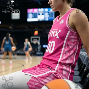 Minnesota Lynx Pink Breast Cancer Awareness Basketball Jersey with white text and geometric side patterns on a player.