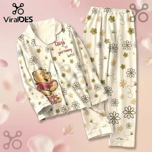Winnie the Pooh 100th Anniversary Satin Pajama Set featuring floral patterns, bees, and text on an off-white background.