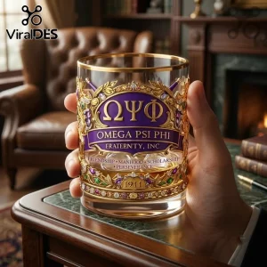 Omega Psi Phi 1911 Gold Trimmed Whiskey Glass featuring a purple emblem, Greek letters, and ornate gold metal detailing.