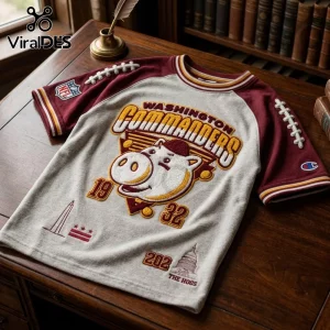 Washington Commanders Mascot Embossed Shirt with hog graphic, burgundy raglan sleeves, and embroidered football lace details.