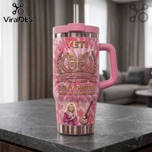 Dolly Parton 80th Anniversary pink Stanley tumbler with butterfly graphic, guitar icon, and 1946-2026 text on a table.