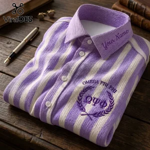 Omega Psi Phi Embroidered Striped Long Sleeve Button-Up Shirt in purple and white on a wooden desk with a fountain pen.