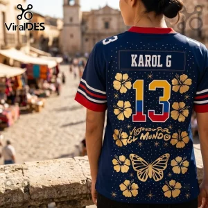 Karol G Tropitour Houston Texans navy blue jersey with gold hibiscus flowers, number 13, and butterfly graphic on back.