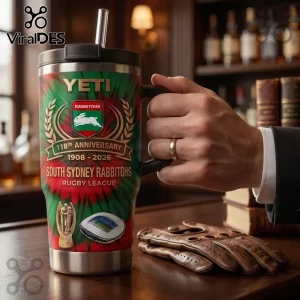 South Sydney Rabbitohs 118th Anniversary 40oz Tumbler with red and green tie-dye pattern and team logo in a bar setting.