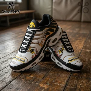 Iowa Hawkeyes NFL Champion Air Max Plus running sneakers featuring black, gold, and white colors on a wooden floor.
