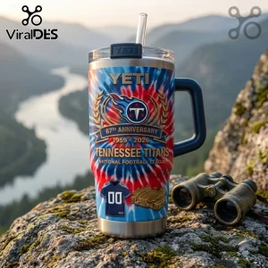 Tennessee Titans 67th Anniversary YETI Stanley Tumbler with red and blue tie-dye pattern on a mountain cliff background.