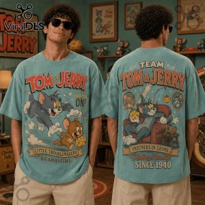 Tom and Jerry 1940 Partners in Crime T-Shirt worn by a man, featuring blue vintage wash, character prints, and graphic text.