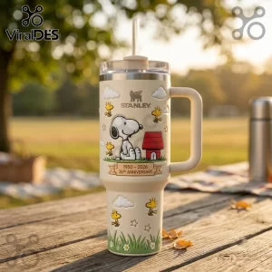 Snoopy x Stanley 76th Anniversary Cream 40oz Tumbler featuring Snoopy, Woodstock, and a red doghouse on a picnic table.