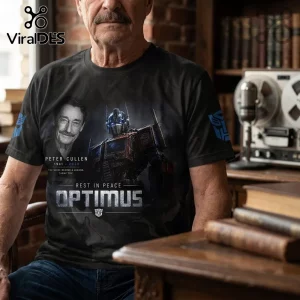 Peter Cullen Optimus Prime 1941-2026 Tribute T-Shirt in black featuring a portrait of Peter Cullen and the Optimus Prime robot.