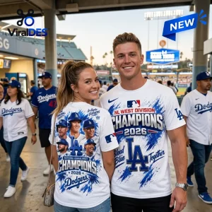 Man and woman wearing Los Angeles Dodgers 2026 NL West Division Champions shirts at a stadium.