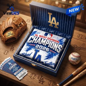 Top-down view of a Los Angeles Dodgers 2026 NL West Division Champions shirt folded inside a branded presentation box.