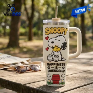 Front view of an off-white tumbler featuring a dog character illustration and the text Happiness Is Friendship.