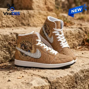 Iron Maiden Powerslave Egyptian High Top Sneaker featuring hieroglyphic patterns, Eddie mascot, and white swoosh on stone.