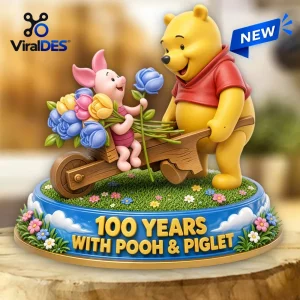 Winnie the Pooh 100th Anniversary Resin Figurine featuring Pooh pushing Piglet in a wheelbarrow with a floral bouquet.