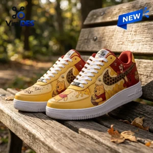 Winnie the Pooh Tigger Nike Air Force 1 Sneakers in yellow and red with honeycomb patterns on a wooden bench.