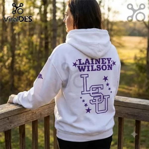 Lainey Wilson x LSU Tigers Football White Hoodie with purple text and university logo on the back, worn outdoors.