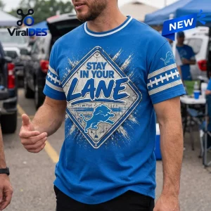 Front view of a blue t-shirt featuring a Detroit Lions logo and a street sign design with the text Stay In Your Lane.